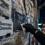 saccage grenoble : tags et prospectus sur mur urbain